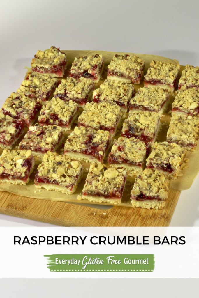 A board with cut gluten free Raspberry Crumble Bars.