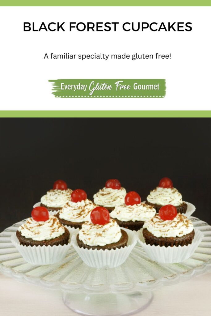 A pedestal tray with Black Forest Cupcakes, each topped with a maraschino cherry.