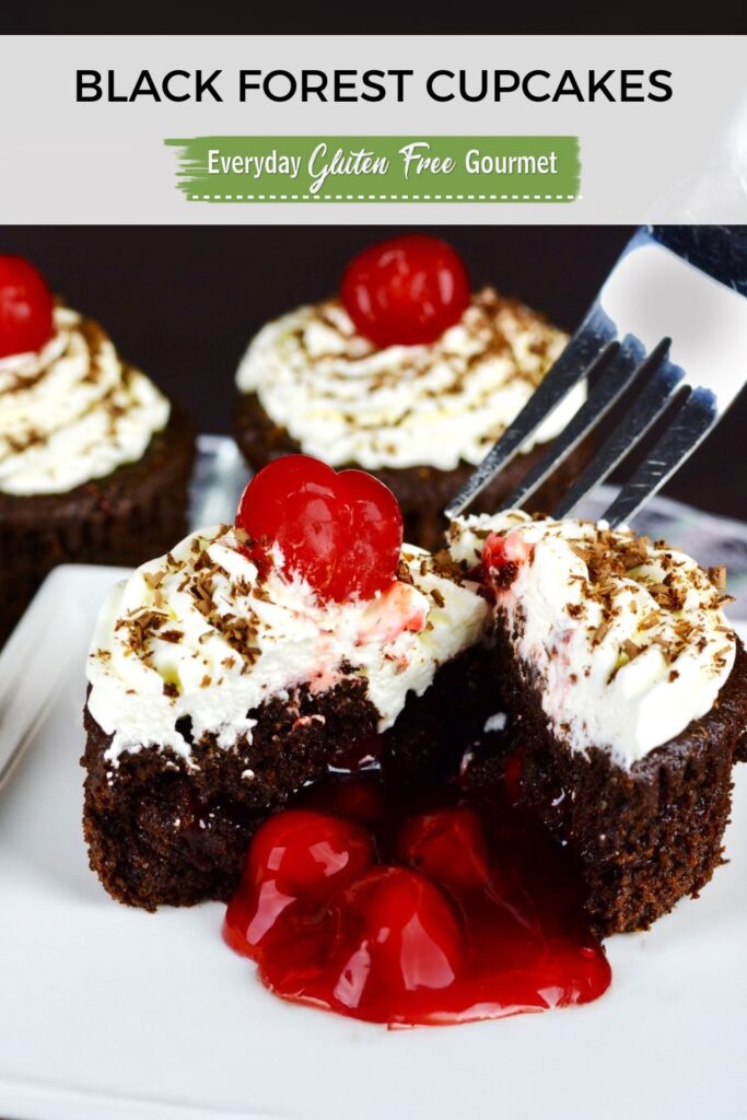 A fork digging into a gluten free Black Forest Cupcake with the cherry pie filling oozing out onto the plate.