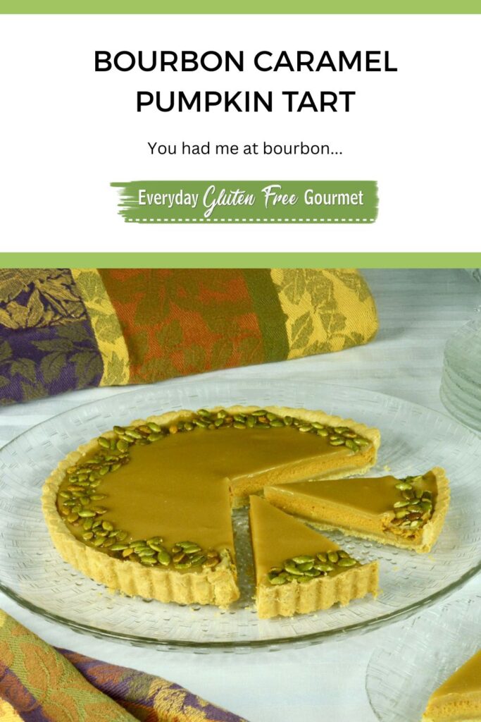 A gluten free Bourbon Caramel Pumpkin Tart on a platter with two pieces cut.