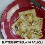 A bowl of gluten free butternut squash ravioli with a knife and fork beside it.
