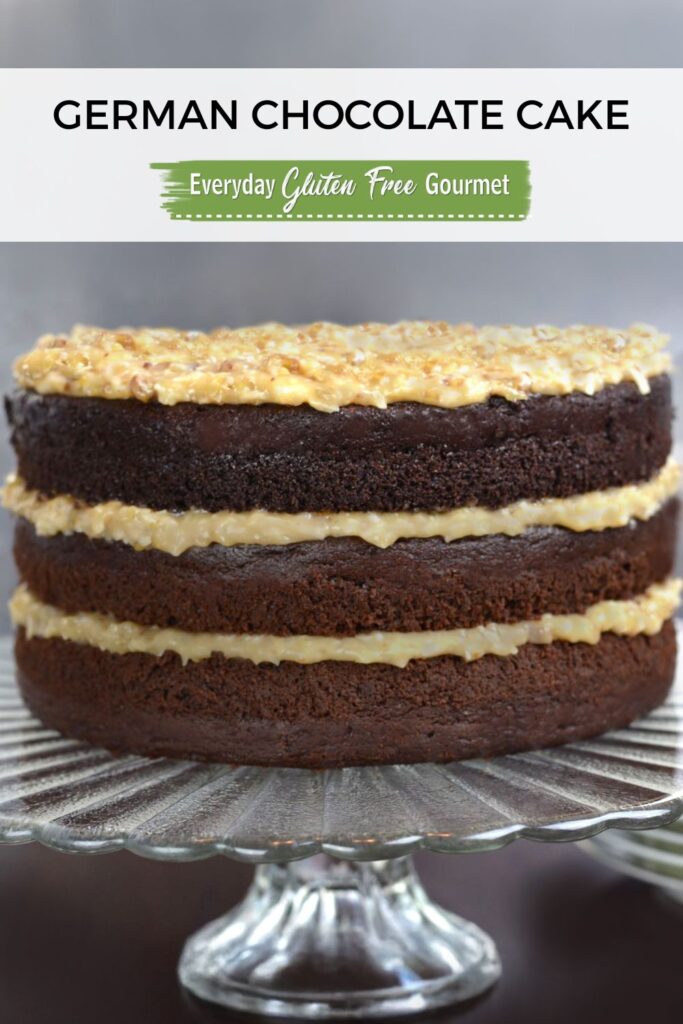 A three layer German Chocolate Cake with coconut-pecan filling on a pedestal tray.
