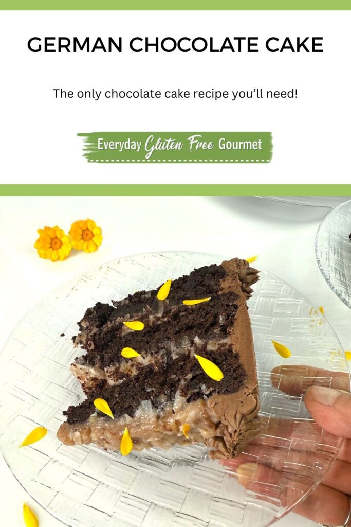 A slice of a three-layered gluten free German Chocolate Cake garnished with calendula flowers and petals.