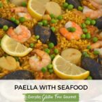 A paella pan filled with Paella with Seafood.