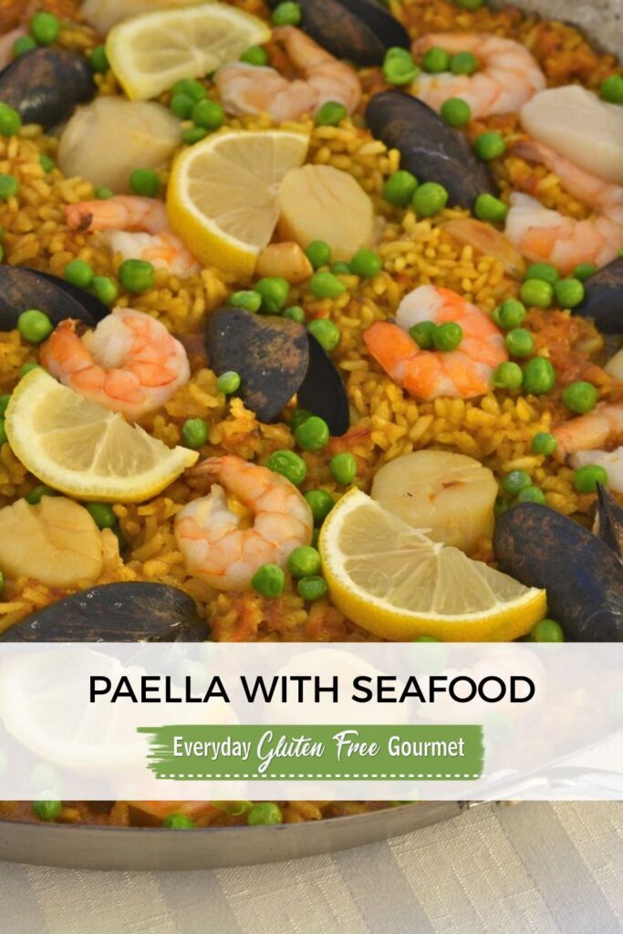 A paella pan filled with Paella with Seafood.