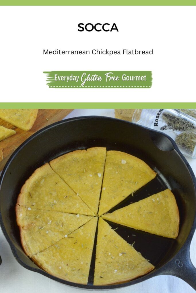 A cast iron frying pan with cooked socca cut in wedges.