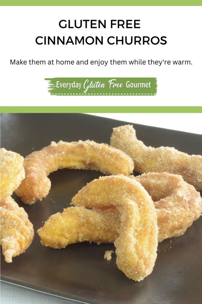 Curled up Cinnamon Churros on a black platter.