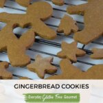 A cooling rack covered in gingerbread men, some with a heart shape space in the center.