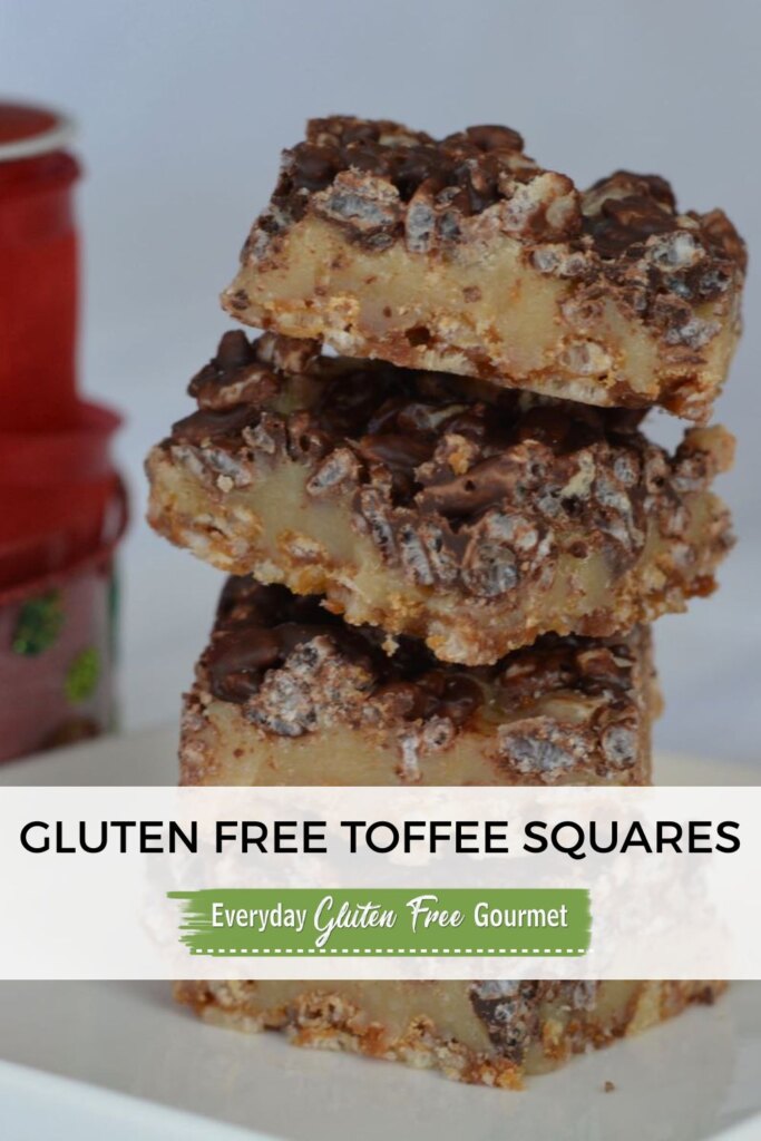 A stack of gluten free toffee squares with Christmas ribbon in the background.