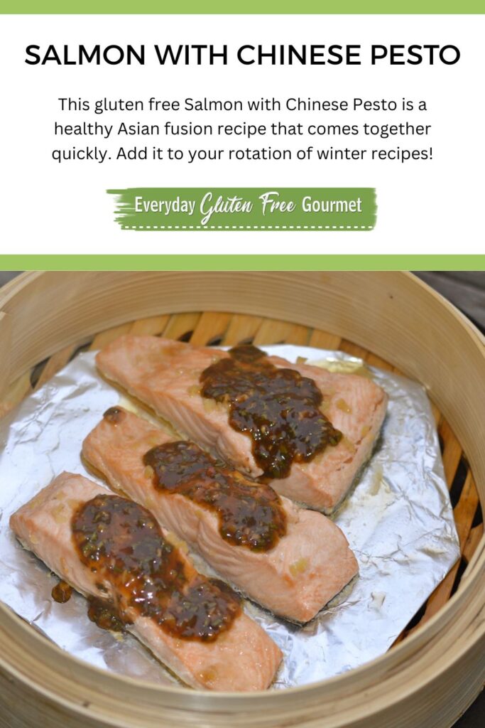 A Chinese steamer with three pieces of cooked Salmon topped with a Chinese-fusion pesto sauce.